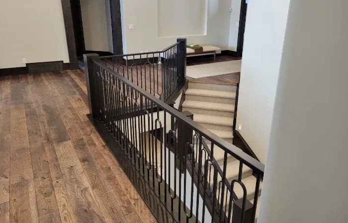 Custom ornamental iron stair railing fabricated and installed by RCM Metal Works