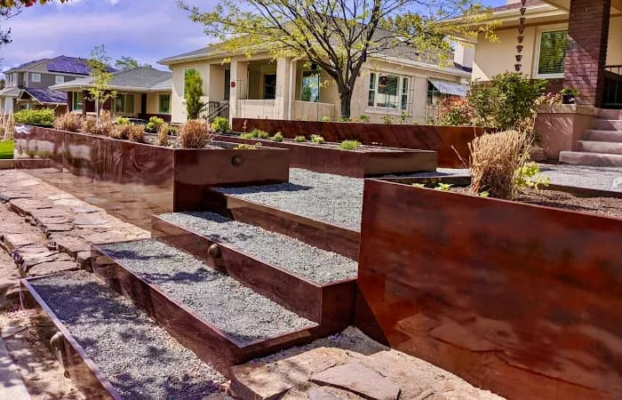 Custom corten steel garden beds and steps for residential landscape